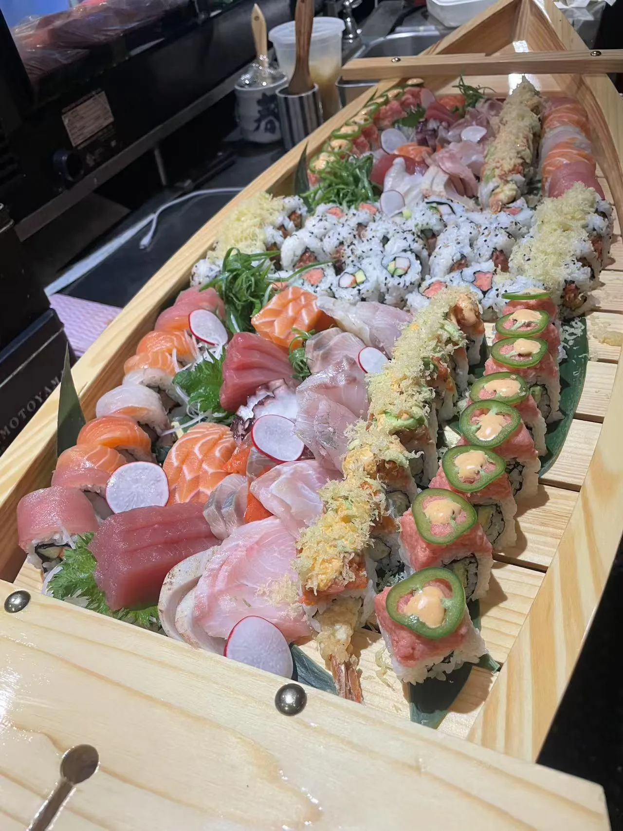 Sushi Boat Platter contains a rich variety of sushi and sashimi, featuring different toppings and fillings at Kokoro Sushi, a Japanese restaurant in CA